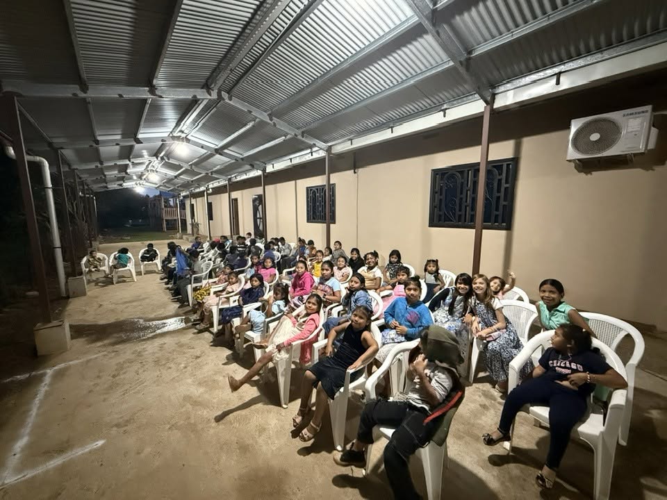 Children seated together at an evening church service in Panama