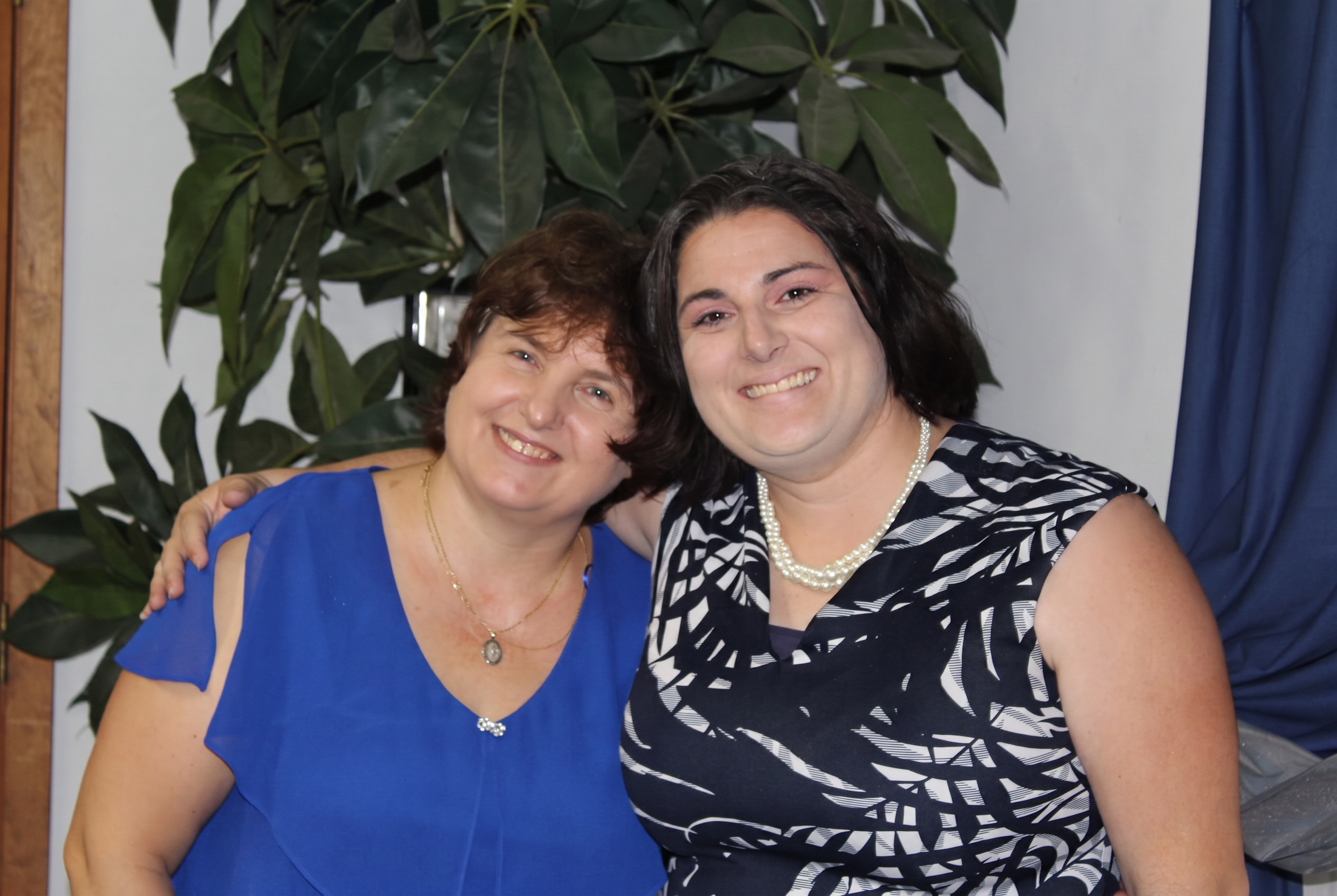 Two young women from the church smiling together after a class