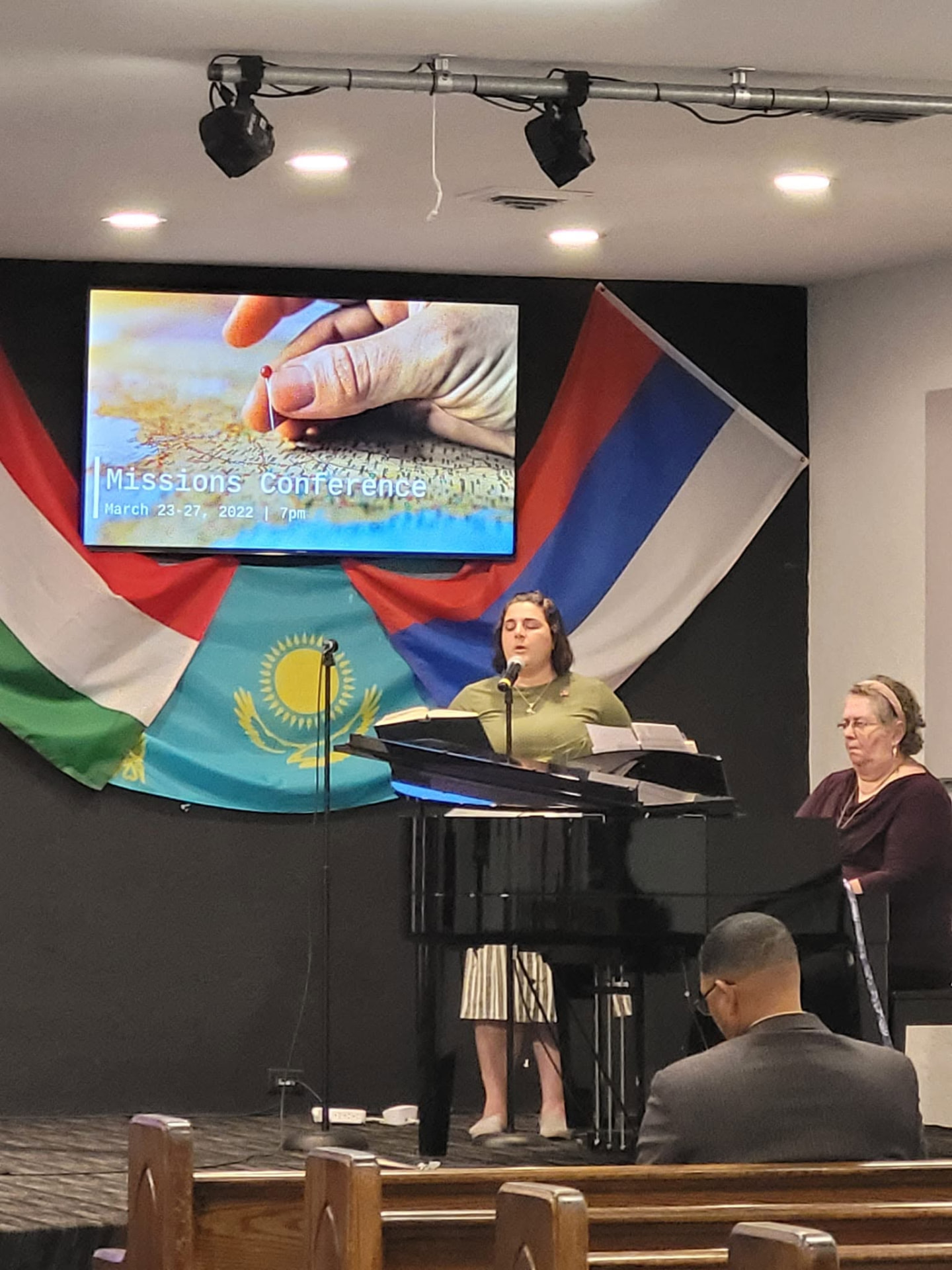 Missions conference service with flags of the nations displayed in the sanctuary