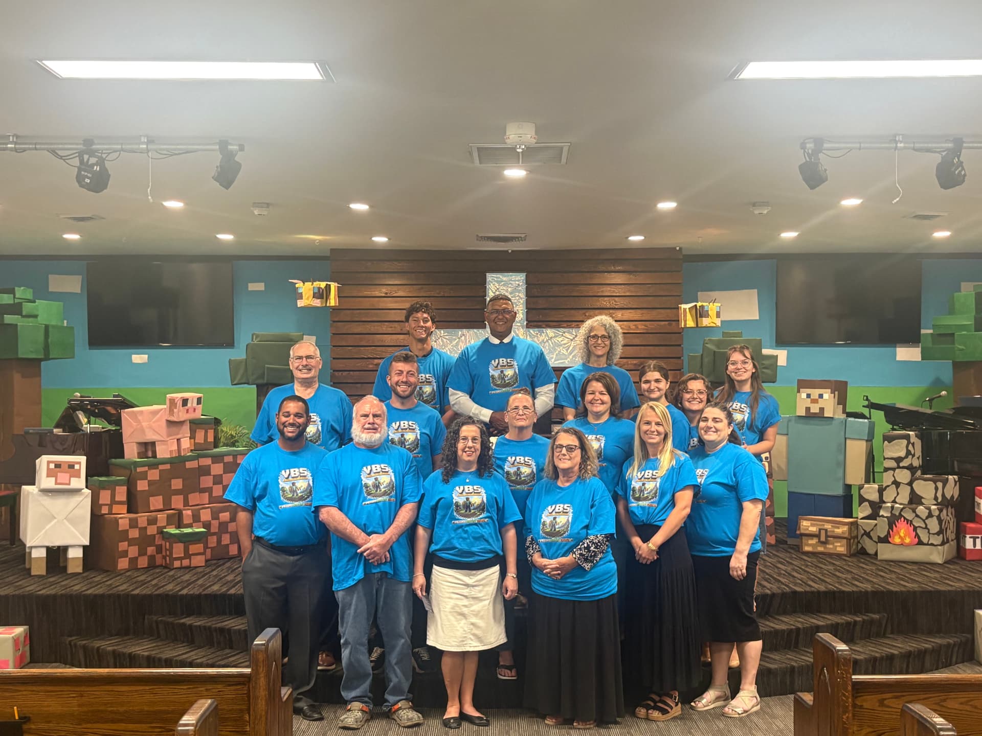 Vacation Bible School staff in blue VBS shirts on the church platform