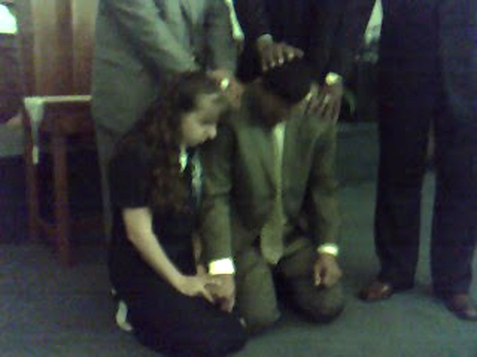 Pastors laying hands on Pastor Kelly in prayer during his ordination