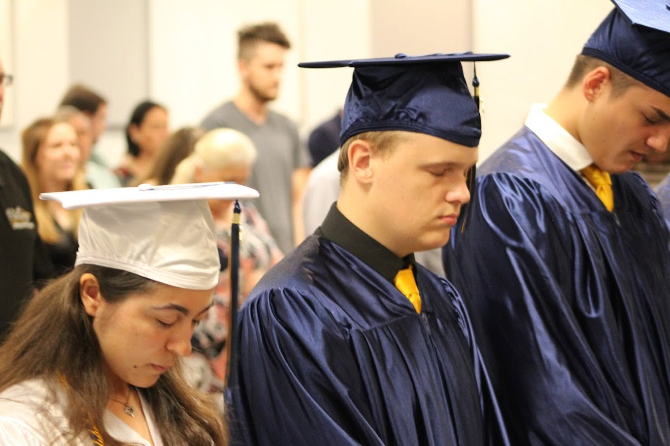 Victory Baptist Academy graduates in caps and gowns during the commencement service