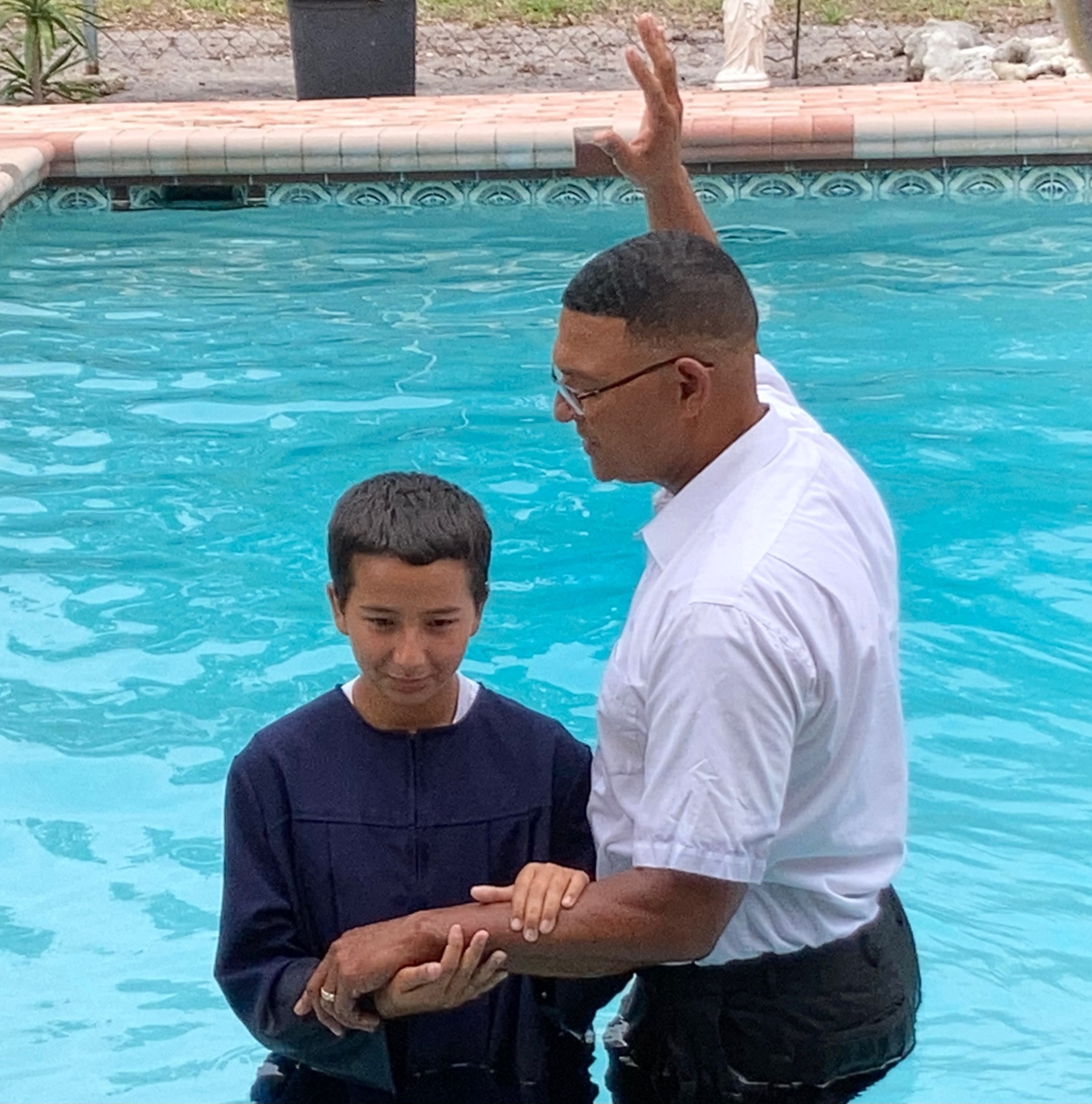 Close-up of a baptism in a swimming pool