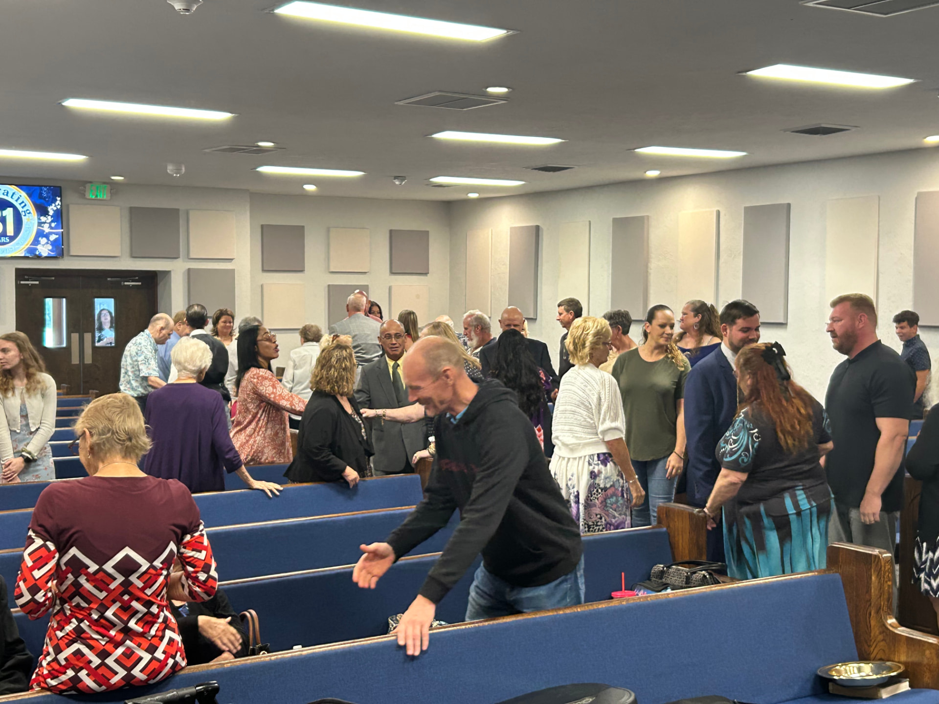 Church family greeting one another in the Victory Baptist sanctuary