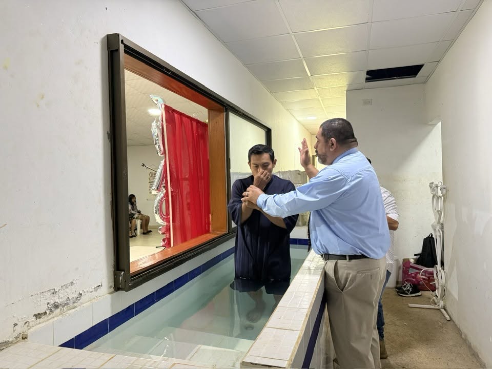 A man being baptized in a church baptistry in Panama